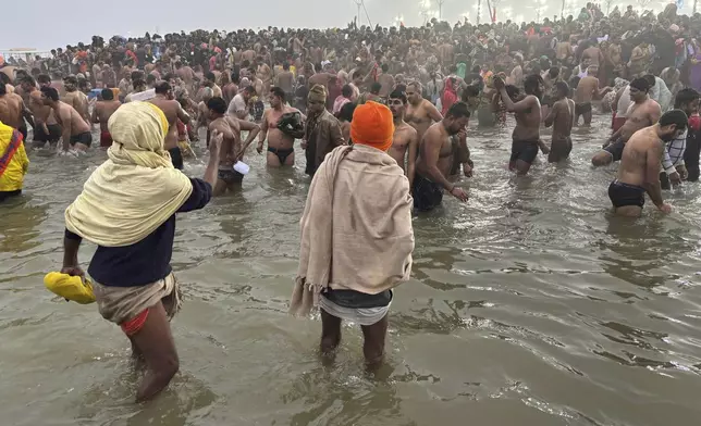 Hindus take holy dips at the confluence of the Ganges, the Yamuna and the mythical Saraswati rivers on Makar Sankranti, an auspicious bathing day of the 45-day-long Maha Kumbh festival in Prayagraj, India, Tuesday, Jan. 14, 2025. (AP Photo/Ashwini Bhatia)