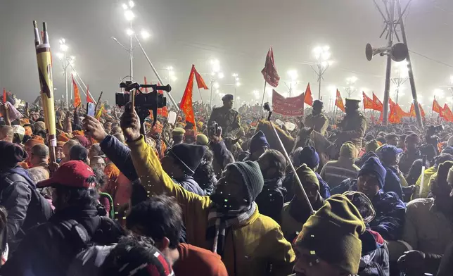 Policemen on horseback control the crowd at the confluence of the Ganges, the Yamuna and the mythical Saraswati rivers on Makar Sankranti, an auspicious bathing day of the 45-day-long Maha Kumbh festival in Prayagraj, India, Tuesday, Jan. 14, 2025. (AP Photo/Ashwini Bhatia)