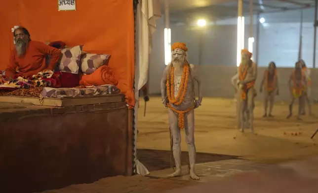 Nude Hindu holy men or a Naga Sadhus of Maharirwani Akhara prepare for a dip at Sangam, the confluence of the Rivers Ganges, Yamuna and mythical Saraswati on one of the most auspicious day Makar Sankranti, for the Mahakumbh festival in Prayagraj, Uttar Pradesh state, India, Tuesday, Jan. 14, 2025. (AP Photo/Rajesh Kumar Singh)