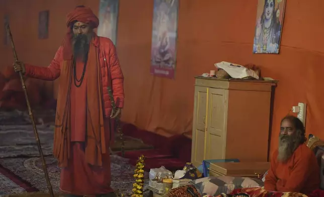 Hindu holy men or a Naga Sadhus of Maharirwani Akhara prepare for a dip at Sangam, the confluence of the Rivers Ganges, Yamuna and mythical Saraswati on one of the most auspicious day Makar Sankranti, for the Mahakumbh festival in Prayagraj, Uttar Pradesh state, India, Tuesday, Jan. 14, 2025. (AP Photo/Rajesh Kumar Singh)