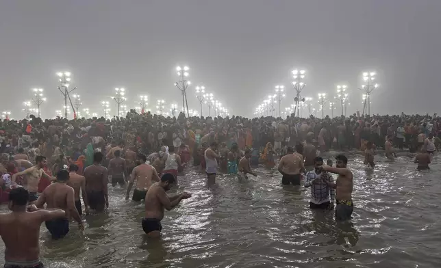 Hindus bathe at the confluence of the Ganges, the Yamuna and the mythical Saraswati rivers on Makar Sankranti, an auspicious day of the 45-day-long Maha Kumbh festival in Prayagraj, India, Tuesday, Jan. 14, 2025. (AP Photo/Ashwini Bhatia)