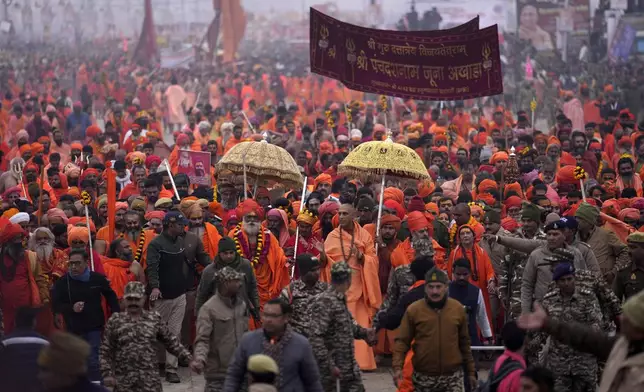 Hindu ascetics arrive for ritualistic dip at Sangam, the confluence of the Rivers Ganges, Yamuna and mythical Saraswati on one of the most auspicious day Makar Sankranti, for the Maha Kumbh festival in Prayagraj, India, Tuesday, Jan. 14, 2025. (AP Photo/Rajesh Kumar Singh)
