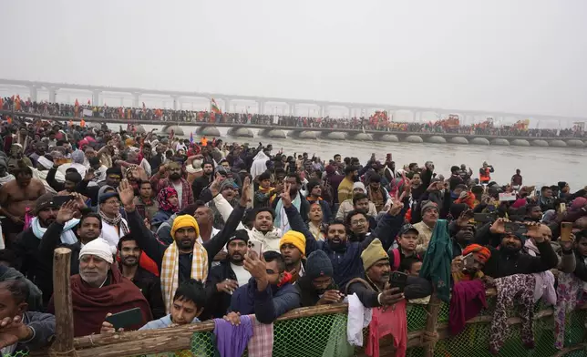 Devout Hindus gather at Sangam, the confluence of the Rivers Ganges, Yamuna and mythical Saraswati on one of the most auspicious day Makar Sankranti, for the Maha Kumbh festival in Prayagraj, India, Tuesday, Jan. 14, 2025. (AP Photo/Rajesh Kumar Singh)