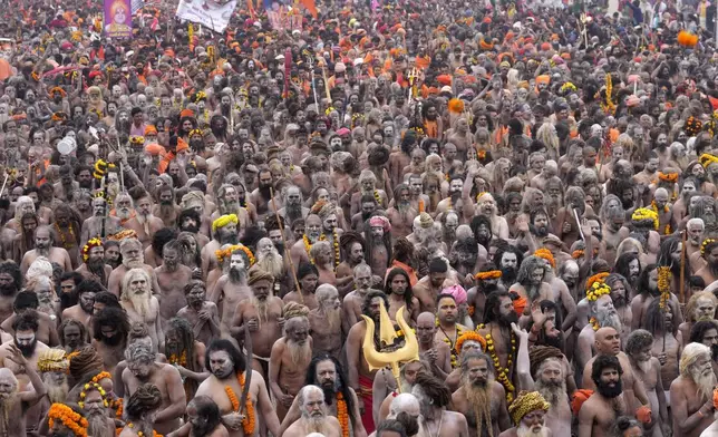 Naga Sadhus for ritualistic dips at Sangam, the confluence of the Rivers Ganges, Yamuna and mythical Saraswati on one of the most auspicious day Makar Sankranti, for the Maha Kumbh festival in Prayagraj, India, Tuesday, Jan. 14, 2025. (AP Photo/Rajesh Kumar Singh)