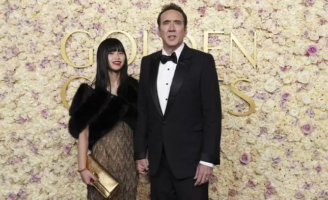 Riko Shibata, left, and Nicolas Cage arrive at the 82nd Golden Globes on Sunday, Jan. 5, 2025, at the Beverly Hilton in Beverly Hills, Calif. (Photo by Jordan Strauss/Invision/AP)