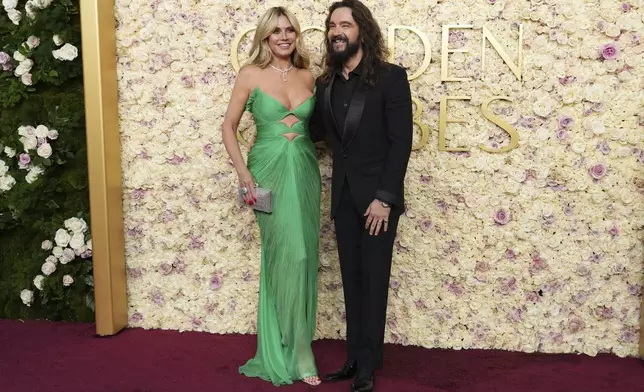 Heidi Klum, left, and Tom Kaulitz arrive at the 82nd Golden Globes on Sunday, Jan. 5, 2025, at the Beverly Hilton in Beverly Hills, Calif. (Photo by Jordan Strauss/Invision/AP)