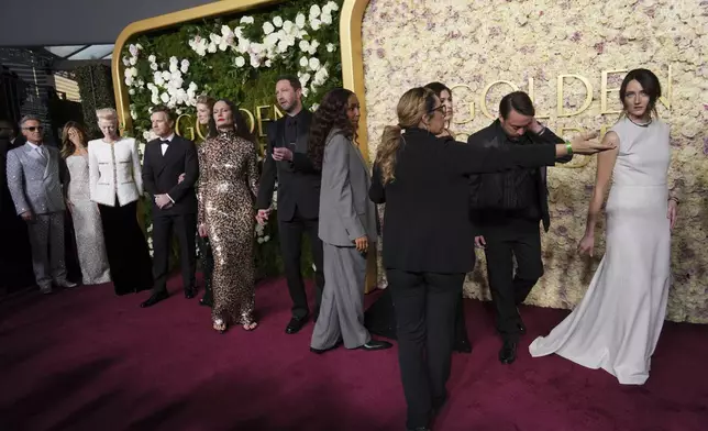 Robbie Williams, from left, Ayda Field, Tilda Swinton, Ewan McGregor, Mary Elizabeth Winstead, Yelena Yemchuk, Ebon Moss-Bachrach, Ayo Edebiri, Jazz Charton, Kerian Culkin, and Martina Scrinzi arrive at the 82nd Golden Globes on Sunday, Jan. 5, 2025, at the Beverly Hilton in Beverly Hills, Calif. (Photo by Jordan Strauss/Invision/AP)