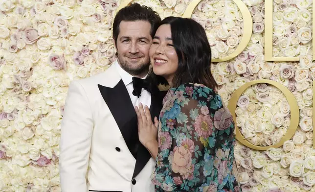 Michael Angarano, left, and Maya Erskine arrive at the 82nd Golden Globes on Sunday, Jan. 5, 2025, at the Beverly Hilton in Beverly Hills, Calif. (Photo by Jordan Strauss/Invision/AP)