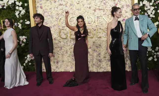 Martina Scrinzi, from left, Giuseppe De Domenico, Salma Hayek, Emilie Livingston, and Jeff Goldblum arrive at the 82nd Golden Globes on Sunday, Jan. 5, 2025, at the Beverly Hilton in Beverly Hills, Calif. (Photo by Jordan Strauss/Invision/AP)