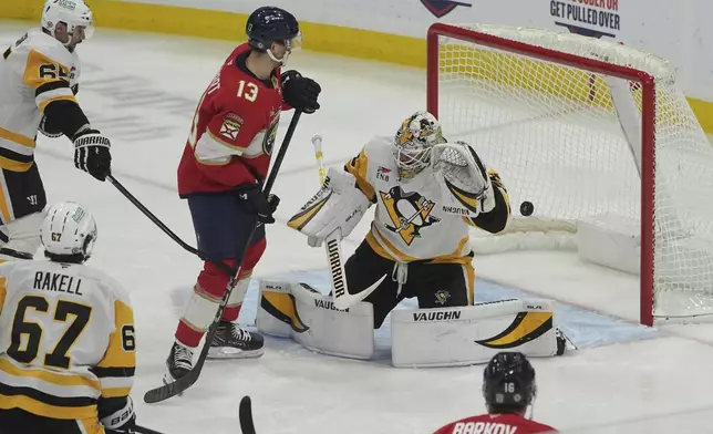 Florida Panthers center Sam Reinhart (13) assists in a goal by defenseman Gustav Forsling against Pittsburgh Penguins goaltender Tristan Jarry (35) during the second period of an NHL hockey game, Friday, Jan. 3, 2025, in Sunrise, Fla. (AP Photo/Marta Lavandier)