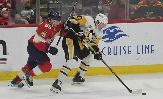 Florida Panthers defenseman Nate Schmidt (88) defends Pittsburgh Penguins left wing Drew O'Connor (10) during the first period of an NHL hockey game, Friday, Jan. 3, 2025, in Sunrise, Fla. (AP Photo/Marta Lavandier)