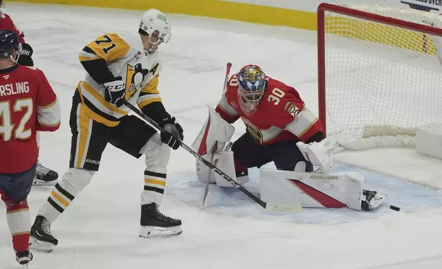 Florida Panthers goaltender Spencer Knight (30) stops a shot on goal by Pittsburgh Penguins center Evgeni Malkin (71) during the first period of an NHL hockey game, Friday, Jan. 3, 2025, in Sunrise, Fla. (AP Photo/Marta Lavandier)