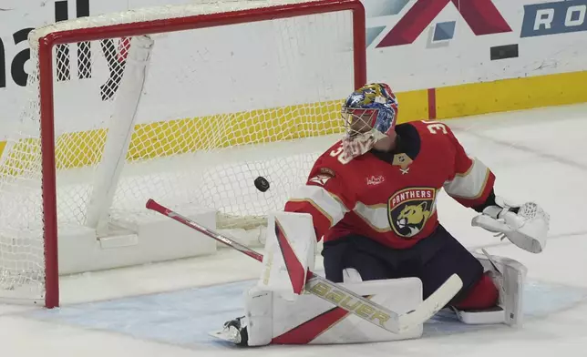 Florida Panthers goaltender Spencer Knight (30) watches as a shot by Pittsburgh Penguins center Sidney Crosby (87) enters the net during the second period of an NHL hockey game, Friday, Jan. 3, 2025, in Sunrise, Fla. (AP Photo/Marta Lavandier)