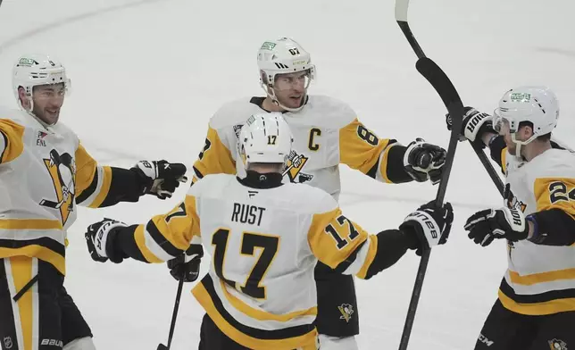 Pittsburgh Penguins center Sidney Crosby (87) celebrates a goal during the second period of an NHL hockey game against the Florida Panthers, Friday, Jan. 3, 2025, in Sunrise, Fla. (AP Photo/Marta Lavandier)