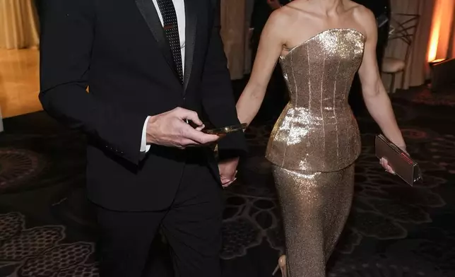 Dax Shepard, left, and Kristen Bell arrive at the 82nd Golden Globes on Sunday, Jan. 5, 2025, at the Beverly Hilton in Beverly Hills, Calif. (AP Photo/Chris Pizzello)