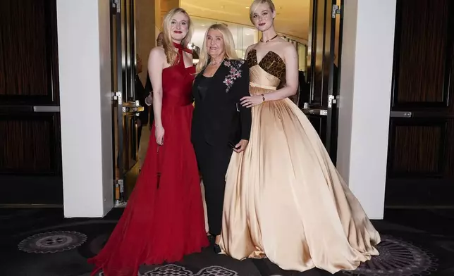 Dakota Fanning, left, and Elle Fanning, right, pose with their grandmother at the 82nd Golden Globes on Sunday, Jan. 5, 2025, at the Beverly Hilton in Beverly Hills, Calif. (AP Photo/Chris Pizzello)