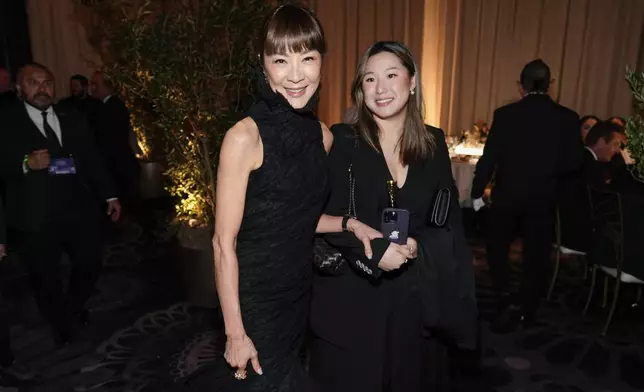 Michelle Yeoh, left, arrives at the 82nd Golden Globes on Sunday, Jan. 5, 2025, at the Beverly Hilton in Beverly Hills, Calif. (AP Photo/Chris Pizzello)