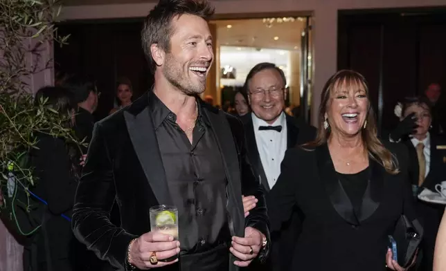 Glen Powell, left, and Cyndy Powell arrive at the 82nd Golden Globes on Sunday, Jan. 5, 2025, at the Beverly Hilton in Beverly Hills, Calif. (AP Photo/Chris Pizzello)