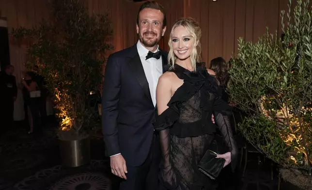 Jason Segel, left, and Kayla Radomski arrive at the 82nd Golden Globes on Sunday, Jan. 5, 2025, at the Beverly Hilton in Beverly Hills, Calif. (AP Photo/Chris Pizzello)