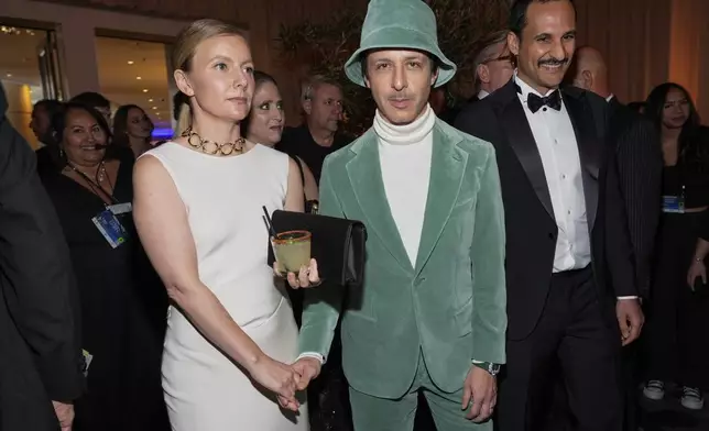 Emma Wall, left, and Jeremy Strong arrive at the 82nd Golden Globes on Sunday, Jan. 5, 2025, at the Beverly Hilton in Beverly Hills, Calif. (AP Photo/Chris Pizzello)