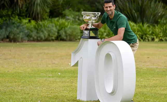 FILE - Novak Djokovic of Serbia poses with the Norman Brookes Challenge Cup in the gardens of Government House the morning after defeating Stefanos Tsitsipas of Greece in the men's singles final at the Australian Open tennis championship in Melbourne, Australia, Monday, Jan. 30, 2023. (AP Photo/Mark Baker, File)