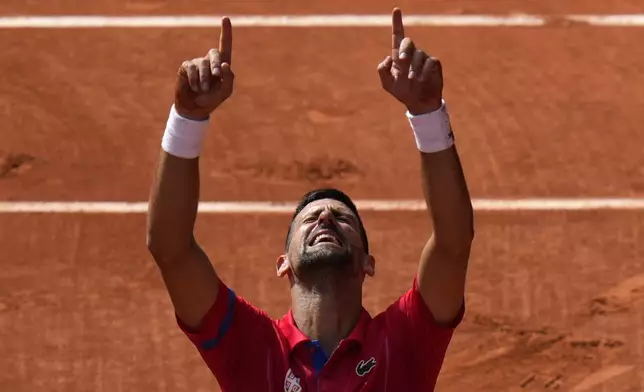 FILE - Serbia's Novak Djokovic points to the sky after defeating Spain's Carlos Alcaraz during the men's singles tennis final at the Roland Garros stadium during the 2024 Summer Olympics, Sunday, Aug. 4, 2024, in Paris, France. (AP Photo/Andy Wong, File)