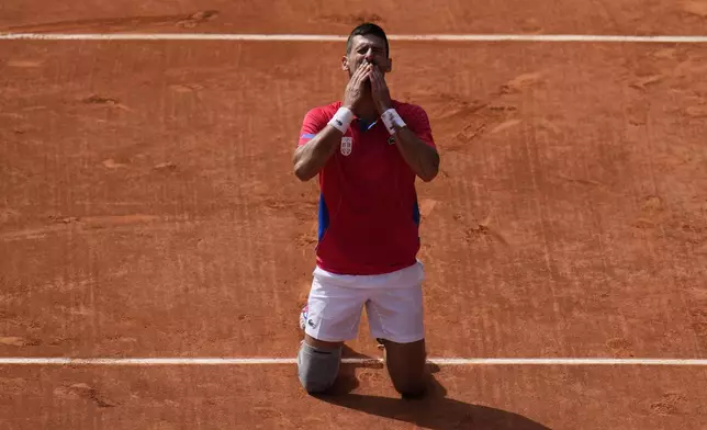 FILE - Serbia's Novak Djokovic blows a kiss after defeating Spain's Carlos Alcaraz in the men's singles tennis final at the Roland Garros stadium during the 2024 Summer Olympics, Sunday, Aug. 4, 2024, in Paris, France. (AP Photo/Andy Wong, File)