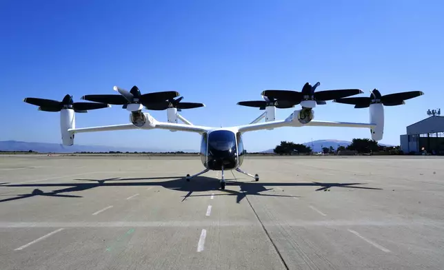 An "electric vertical take-off and landing" aircraft built by Joby Aviation is parked at an airfield in Marina, Calif. on Monday, Oct. 7, 2024. (AP Photo/Terry Chea)