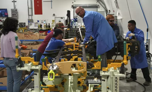 Joby Aviation employees assemble parts for an "electric vertical takeoff and landing" eVTOL aircraft in Marina, Calif. on Monday, Oct. 7, 2024. (AP Photo/Terry Chea)