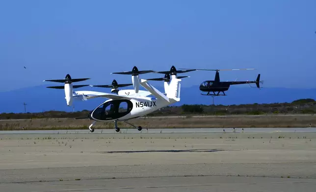 An "electric vertical take-off and landing" aircraft built by Joby Aviation lands at an airfield in Marina, Calif. on Monday, Oct. 7, 2024. (AP Photo/Terry Chea)