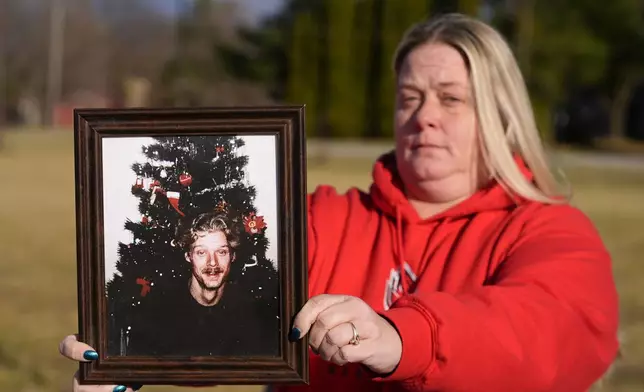 Shannon Doughty holds a photo of her late brother Allen Livingston, who was identified in October 2023 as the ninth known victim of suspected serial killer Herbert Baumeister, Saturday, Dec. 21, 2024, in Westfield, Ind. (AP Photo/Darron Cummings)