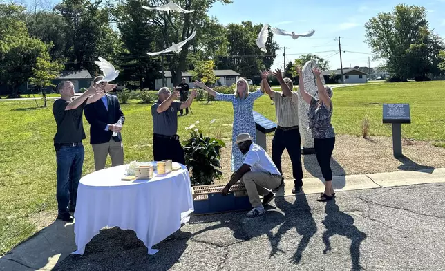 White doves are released on Aug. 29, 2024, in Westfield, Indiana, during the dedication of a memorial to the nine known victims of suspected serial killer Herbert Baumeister. (AP Photo/Rick Callahan)