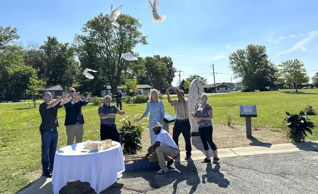 White doves are released on Aug. 29, 2024, in Westfield, Indiana, during the dedication of a memorial to the nine known victims of suspected serial killer Herbert Baumeister. (AP Photo/Rick Callahan)