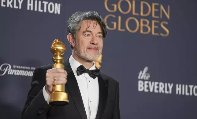 Peter Straughan poses in the press room with the award for best screenplay - motion picture for "Conclave" during the 82nd Golden Globes on Sunday, Jan. 5, 2025, at the Beverly Hilton in Beverly Hills, Calif. (AP Photo/Chris Pizzello)