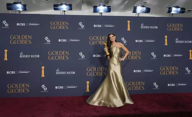 Demi Moore poses in the press room with the award for best performance by a female actor in a motion picture - musical or comedy for "The Substance" during the 82nd Golden Globes on Sunday, Jan. 5, 2025, at the Beverly Hilton in Beverly Hills, Calif. (AP Photo/Chris Pizzello)