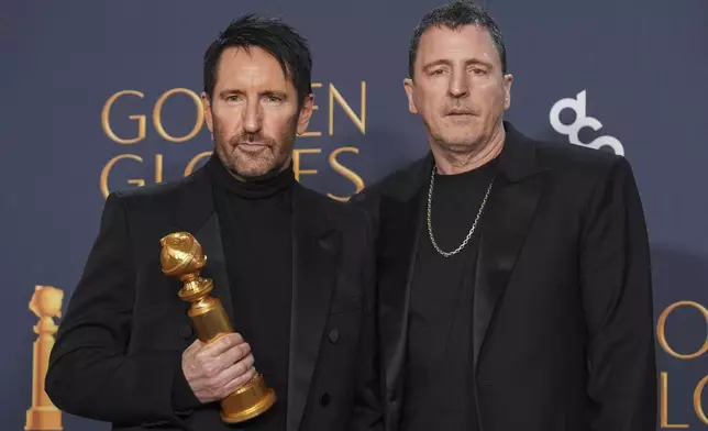 Trent Reznor, left, and Atticus Ross pose in the press room with the award for best original score - motion picture for "Challengers" during the 82nd Golden Globes on Sunday, Jan. 5, 2025, at the Beverly Hilton in Beverly Hills, Calif. (AP Photo/Chris Pizzello)