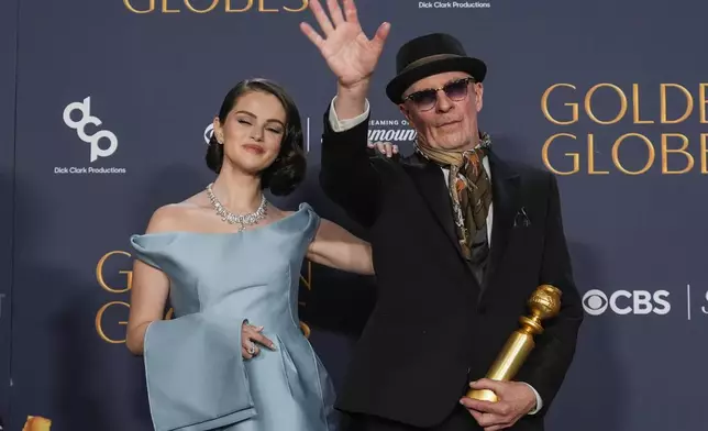 Selena Gomez, left, and Jacques Audiard pose in the press room with the award for best motion picture - musical or comedy for "Emilia Perez" during the 82nd Golden Globes on Sunday, Jan. 5, 2025, at the Beverly Hilton in Beverly Hills, Calif. (AP Photo/Chris Pizzello)