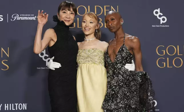 Michelle Yeoh, from left, Ariana Grande, and Cynthia Erivo pose in the press room during the 82nd Golden Globes on Sunday, Jan. 5, 2025, at the Beverly Hilton in Beverly Hills, Calif. (AP Photo/Chris Pizzello)