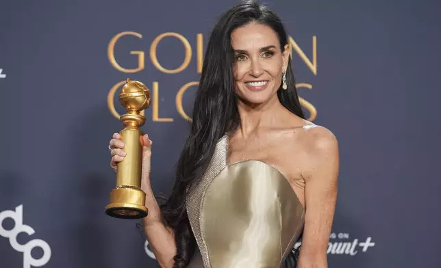 Demi Moore poses in the press room with the award for best performance by a female actor in a motion picture - musical or comedy for "The Substance" during the 82nd Golden Globes on Sunday, Jan. 5, 2025, at the Beverly Hilton in Beverly Hills, Calif. (AP Photo/Chris Pizzello)