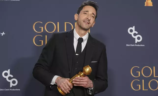 Adrien Brody poses in the press room with the award for best performance by a male actor in a motion picture - drama for "The Brutalist" during the 82nd Golden Globes on Sunday, Jan. 5, 2025, at the Beverly Hilton in Beverly Hills, Calif. (AP Photo/Chris Pizzello)