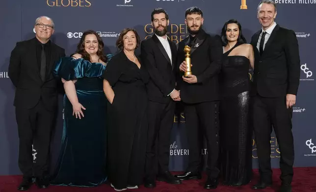 Wim De Greef, from left, Jessica Gunning, Petra Fried, Ed Macdonald, Richard Gadd, Nava Mau, and Matt Jarvis pose in the press room with the award for best television limited series, anthology series, or motion picture made for television for "Baby Reindeer" during the 82nd Golden Globes on Sunday, Jan. 5, 2025, at the Beverly Hilton in Beverly Hills, Calif. (AP Photo/Chris Pizzello)