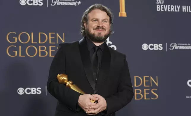 Brady Corbet poses in the press room with the award for best director - motion picture for "The Brutalist" in the press room during the 82nd Golden Globes on Sunday, Jan. 5, 2025, at the Beverly Hilton in Beverly Hills, Calif. (AP Photo/Chris Pizzello)