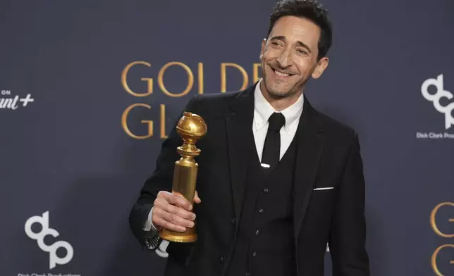 Adrien Brody poses in the press room with the award for best performance by a male actor in a motion picture - drama for "The Brutalist" during the 82nd Golden Globes on Sunday, Jan. 5, 2025, at the Beverly Hilton in Beverly Hills, Calif. (AP Photo/Chris Pizzello)