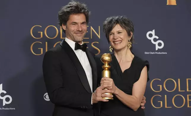 Clément Ducol, left, and Camille pose in the press room with the award for best original song - motion picture for "El Mal," from "Emilia Perez" in the press room during the 82nd Golden Globes on Sunday, Jan. 5, 2025, at the Beverly Hilton in Beverly Hills, Calif. (AP Photo/Chris Pizzello)