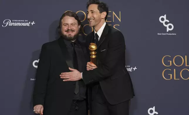 Brady Corbet, winner of the award for best director - motion picture for "The Brutalist", left, Adrien Brody, winner of the award for best performance by a male actor in a motion picture - drama for "The Brutalist", pose in the press room during the 82nd Golden Globes on Sunday, Jan. 5, 2025, at the Beverly Hilton in Beverly Hills, Calif. (AP Photo/Chris Pizzello)