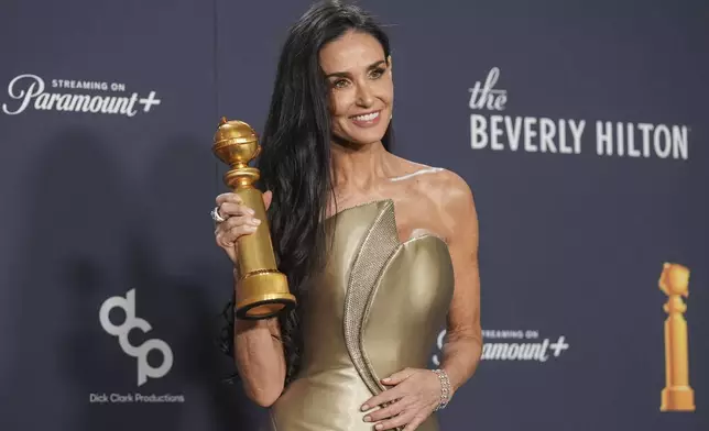 Demi Moore poses in the press room with the award for best performance by a female actor in a motion picture - musical or comedy for "The Substance" during the 82nd Golden Globes on Sunday, Jan. 5, 2025, at the Beverly Hilton in Beverly Hills, Calif. (AP Photo/Chris Pizzello)