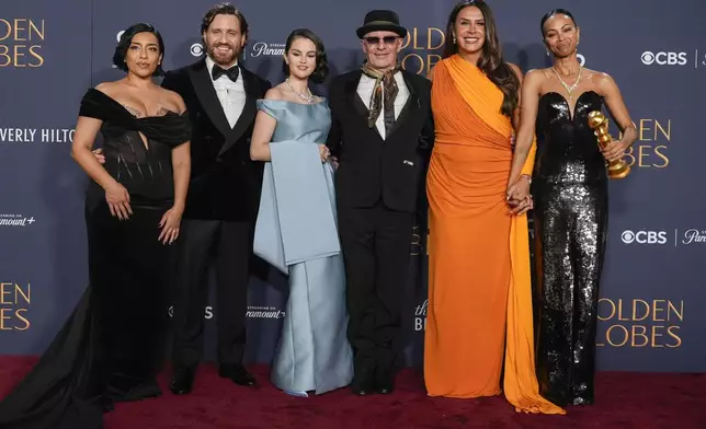 Adriana Paz, from left, Edgar Ramirez, Selena Gomez, Jacques Audiard, Karla Sofia Gascon, and Zoe Saldana pose in the press room with the award for best motion picture - musical or comedy for "Emilia Perez" during the 82nd Golden Globes on Sunday, Jan. 5, 2025, at the Beverly Hilton in Beverly Hills, Calif. (AP Photo/Chris Pizzello)