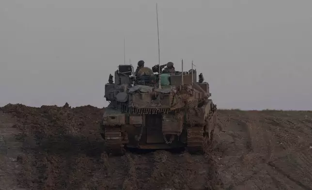 An israeli army vehicle is seen near the Israeli-Gaza border, Wednesday, Jan. 1, 2025. (AP Photo/Ohad Zwigenberg)