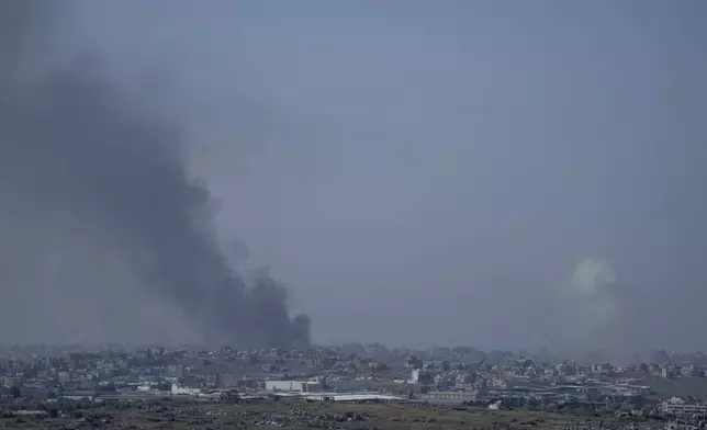 Smoke rises following an explosion in the Gaza Strip as seen from southern Israel, Wednesday, Jan. 1, 2025.(AP Photo/Ohad Zwigenberg)