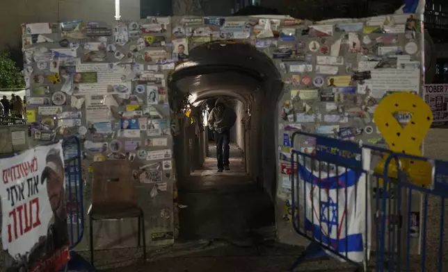 A man walks through a tunnel symbolising the Hamas tunnels, amidst the ongoing conflict between Israel and Hamas, in Tel Aviv, Israel, Wednesday, Jan. 1, 2025. (AP Photo/Matias Delacroix)